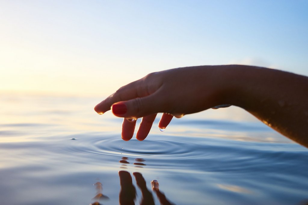 Supernatural Healing - Charis Christian Center | hand touching water creating ripples