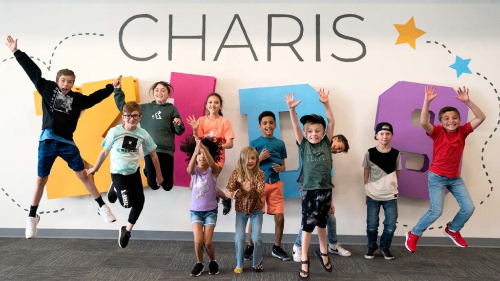 Kids in front of Charis Kids sign